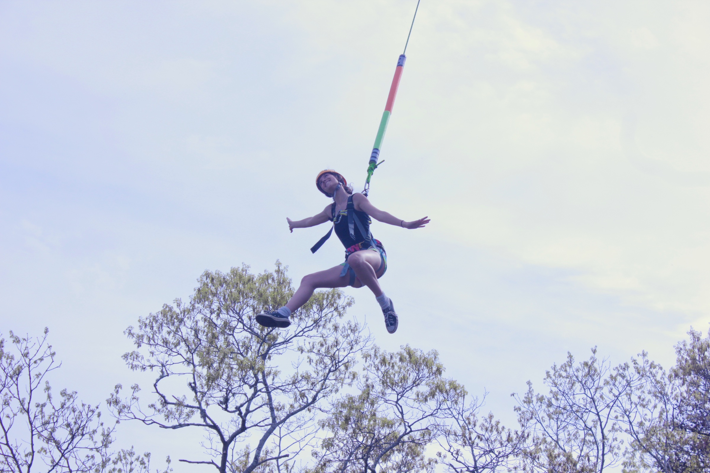 A YFC Cape Cod student riding a zipline during an outdoor adventure day