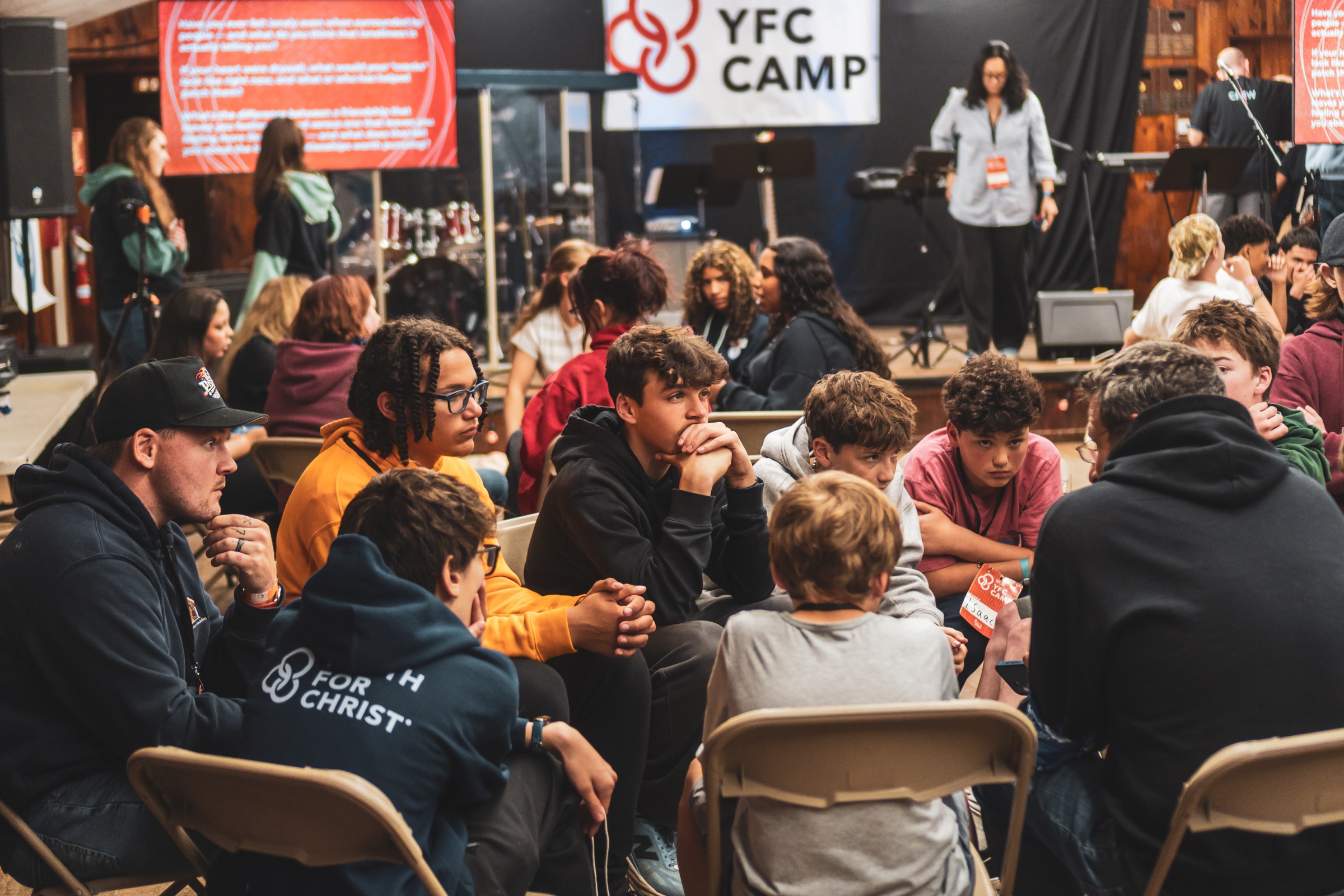 YFC Cape Cod students and leaders talking in small groups at camp