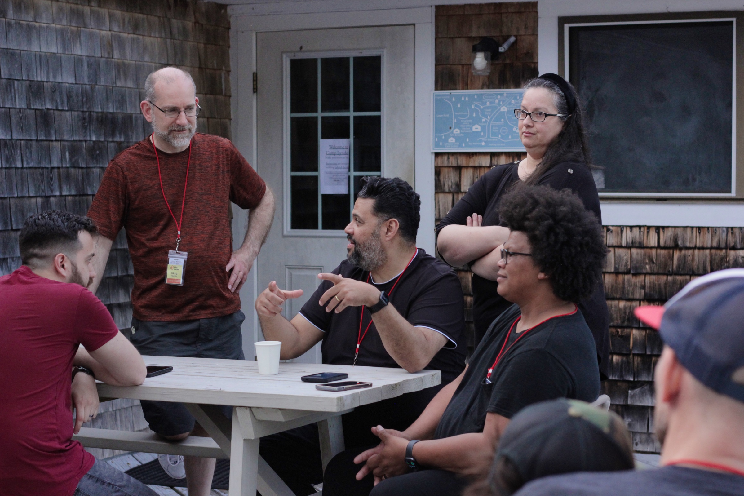 Youth for Christ Cape Cod leaders sharing conversation around an outdoor table
